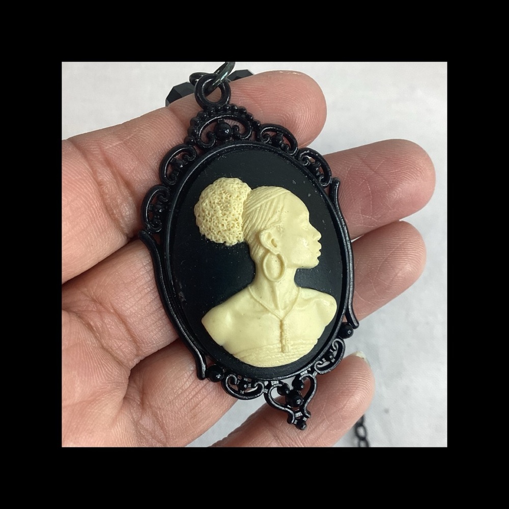 Cream cameo lady with black beads necklace.